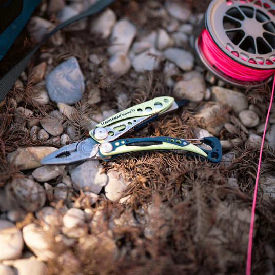 Translation missing: en.Skeletool CX open on the ground near fishing line