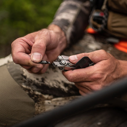 Translation missing: en.A man replacing a bit on a Leatherman Wave