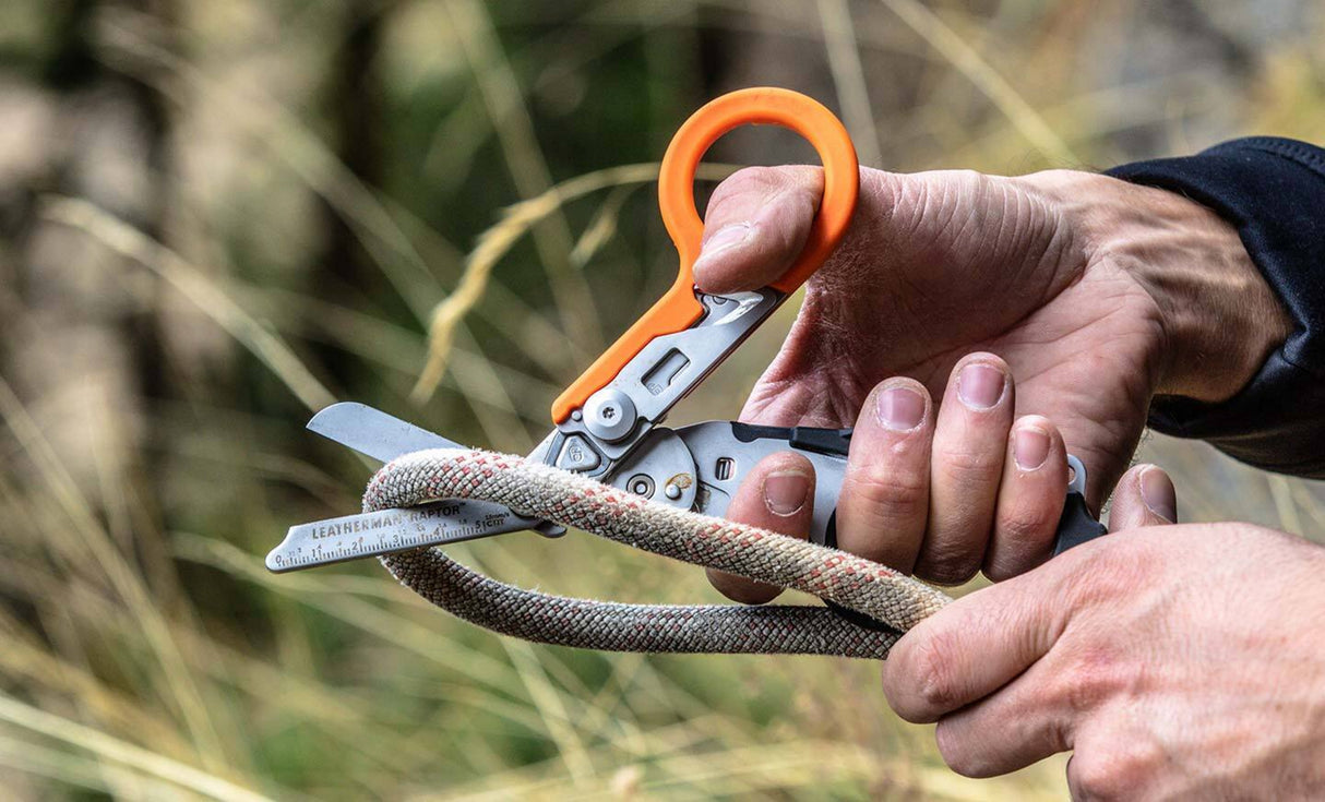 Translation missing: en.Person using Raptor Rescue shears to cut a thick rope