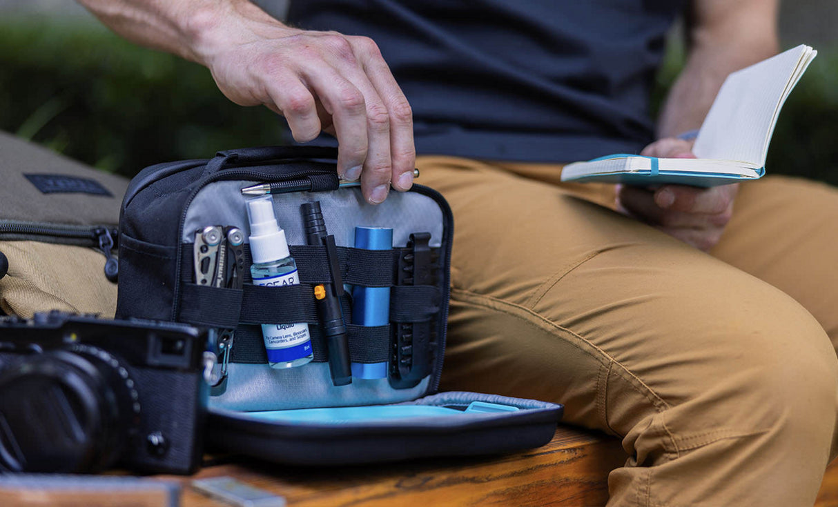 Translation missing: en.Man pulling pen from LeathermanĀ® Adapt Kit to write on notepad