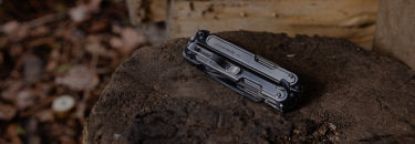 Translation missing: en.Leatherman Arc rests on a wooden surface, showcasing its sleek design against the natural texture of the wood