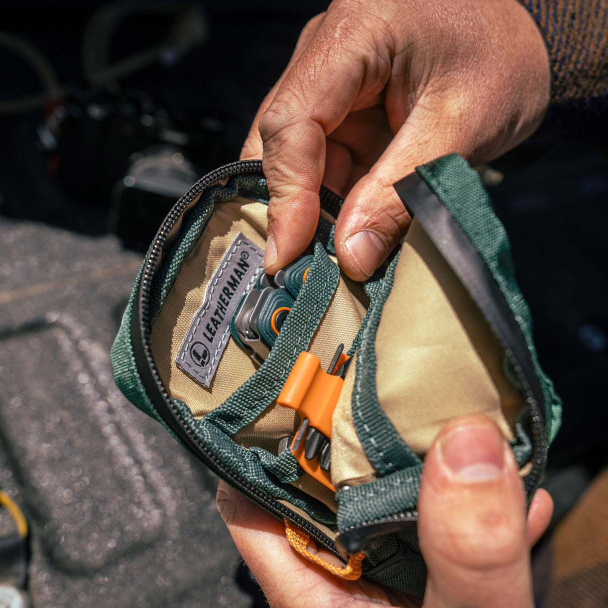 Translation missing: en.A person holds Leatherman Hunter Tool Pouch, showcasing its compact size and practical design