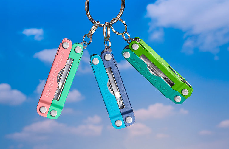 Translation missing: en.Four Skeletool® CX on a rock surface, varying colors