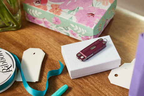 A closed Micra laying on top of a gift box that is on a table