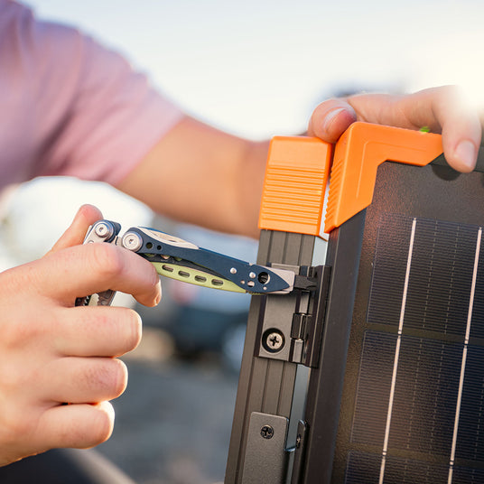 Using the Skeletool CX screwdriver to tighten a screw on a camp stove