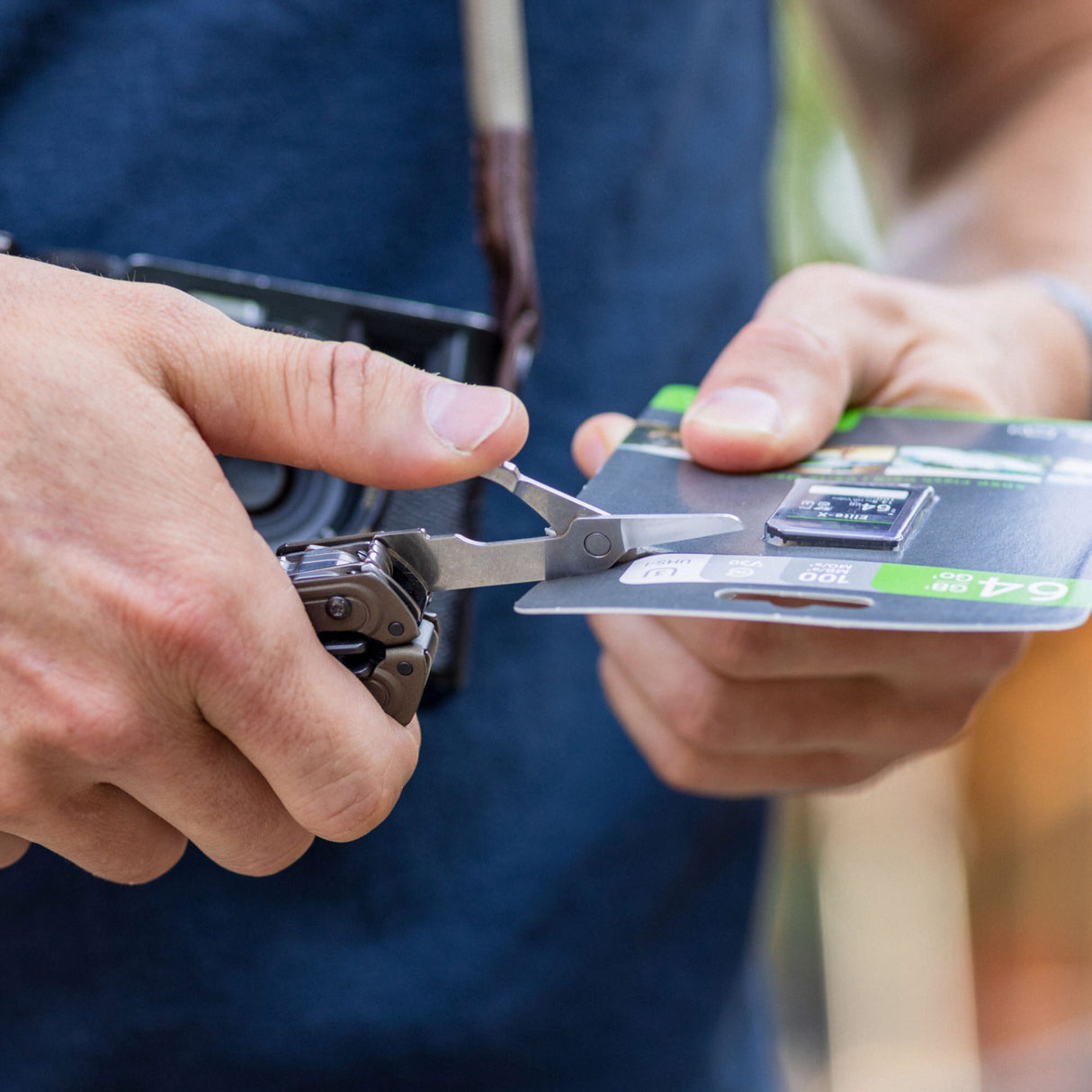 Translation missing: en.ARC Talos one-hand access scissors being used to open SD card packaging