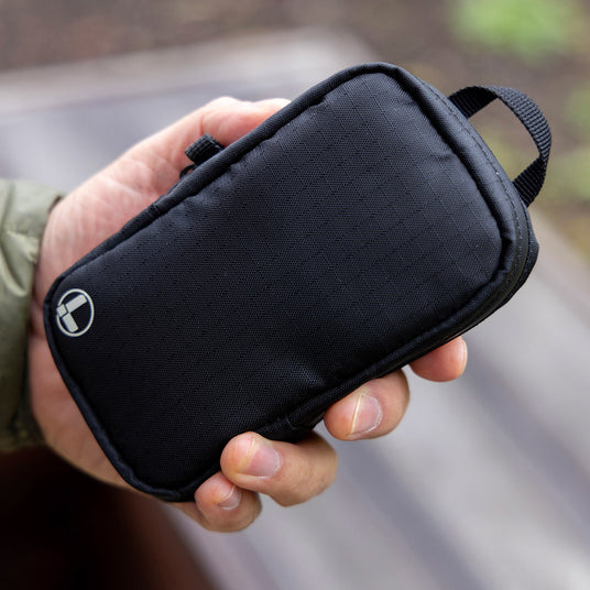 Translation missing: en.Black Leatherman Tool Pouch held in hand, showcasing a sleek and durable design perfect for organizing tools