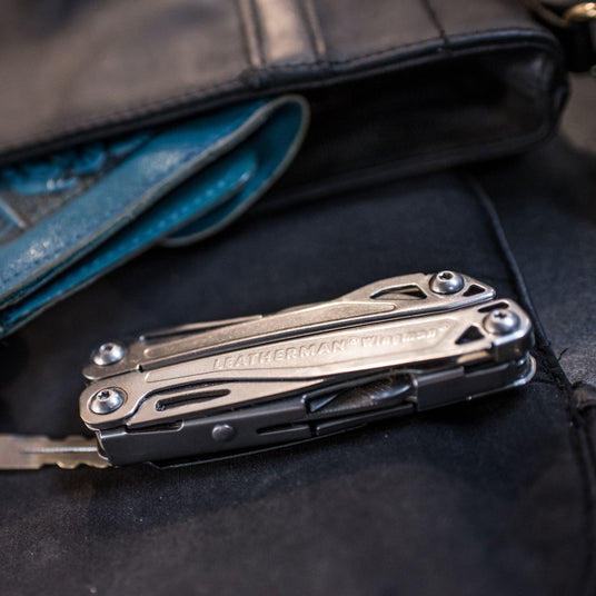 A closed Wingman next to a wallet and key.