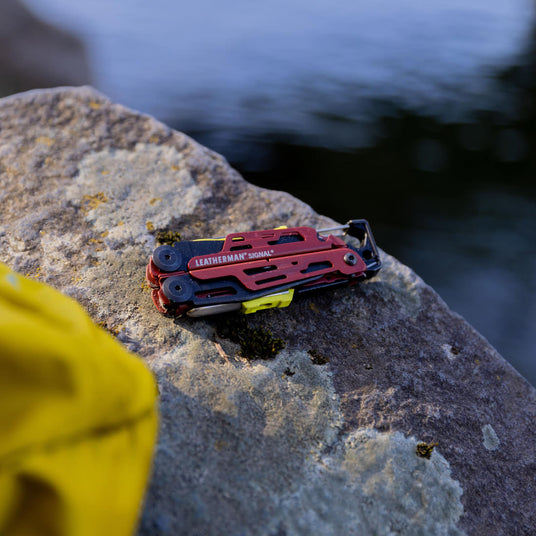 A closed Signal laying on top of a rock outside