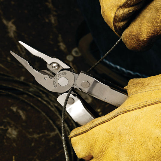 Person wearing yellow safety gloves using Rebar wire stripper. 