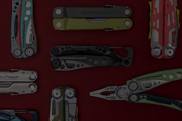 Translation missing: en.A variety of Leatherman tools in different styles are arranged on a vibrant red surface