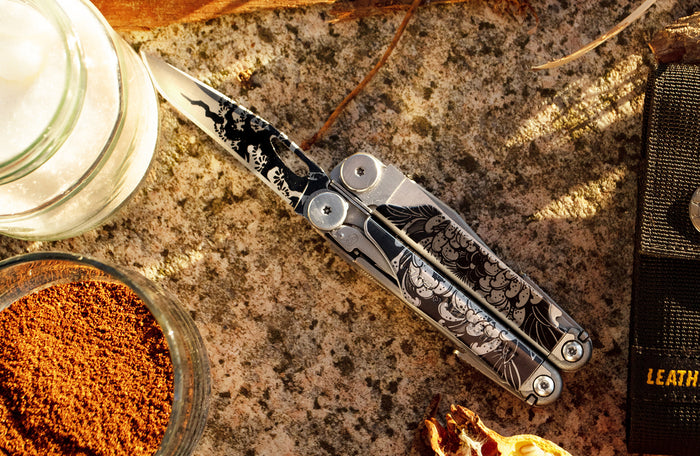 Translation missing: en.Customized stainless steel Leatherman Wave® Plus multitool with intricate design on a kitchen countertop