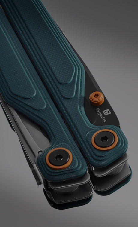 Translation missing: en.Leatherman Wave Alpha with orange and blue handle resting on a neutral background